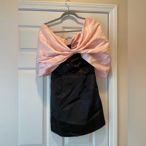Off the shoulder satin bow dress. Black mini dress with large light pink bow.